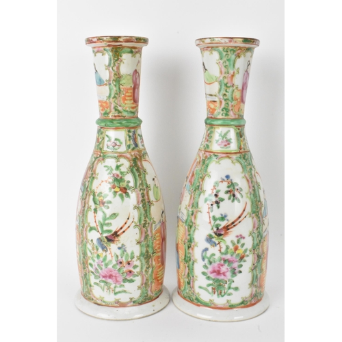 9 - A pair of Chinese late 19th century Canton Famille Rose vases, of cylindrical tapered form, the bodi... 