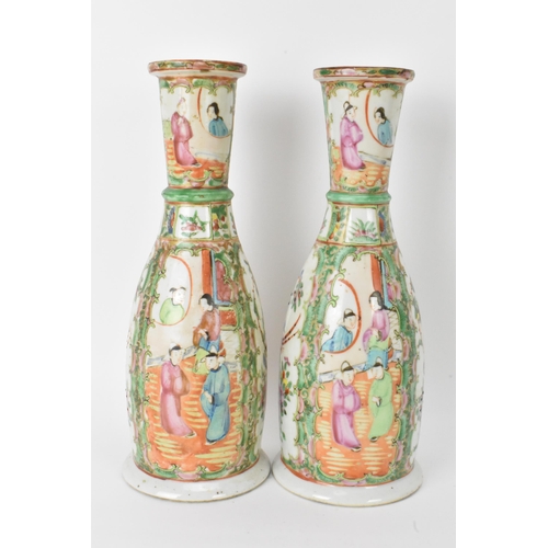 9 - A pair of Chinese late 19th century Canton Famille Rose vases, of cylindrical tapered form, the bodi... 