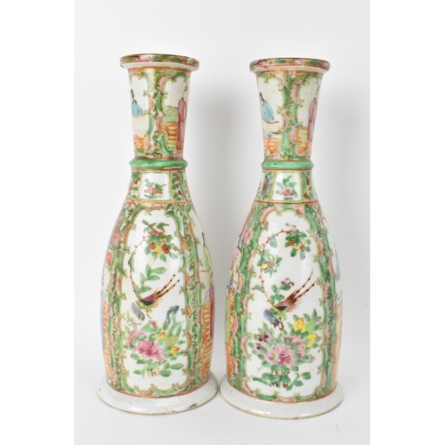 9 - A pair of Chinese late 19th century Canton Famille Rose vases, of cylindrical tapered form, the bodi... 