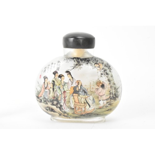 226 - Three Chinese 20th century glass painted snuff bottles, one depicting figures in conversation in a c... 