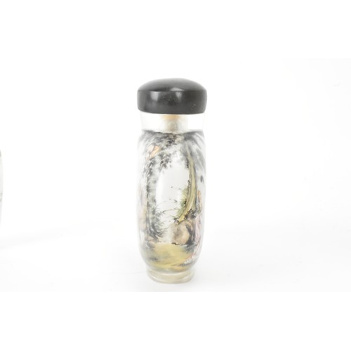 226 - Three Chinese 20th century glass painted snuff bottles, one depicting figures in conversation in a c... 