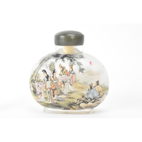 226 - Three Chinese 20th century glass painted snuff bottles, one depicting figures in conversation in a c... 