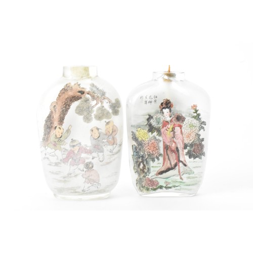 226 - Three Chinese 20th century glass painted snuff bottles, one depicting figures in conversation in a c... 