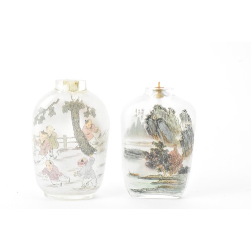 226 - Three Chinese 20th century glass painted snuff bottles, one depicting figures in conversation in a c... 