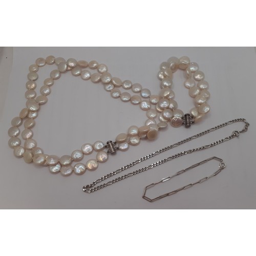 54 - A freshwater coin pearl 2-string necklace and matching bracelet having silver clasps, an engraved si... 