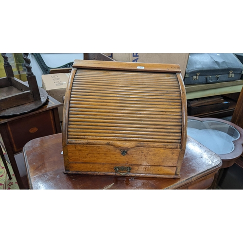 68 - A late Victorian oak table top letter/stationery cabinet having a tambour roll top, fitted interior ... 