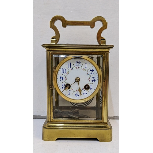 73 - A large early 20th century brass cased carriage style clock with a painted dial and gong strike
Loca... 