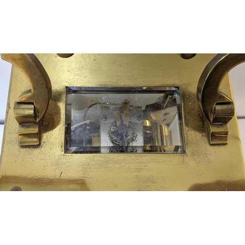 73 - A large early 20th century brass cased carriage style clock with a painted dial and gong strike
Loca... 