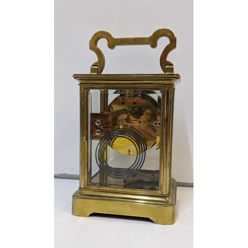 73 - A large early 20th century brass cased carriage style clock with a painted dial and gong strike
Loca... 