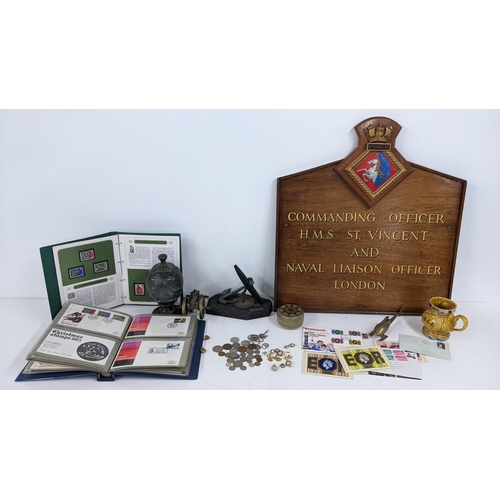 75 - A mixed lot to include a naval plaque, naval related badges and cufflinks, brass model of a canon fi... 