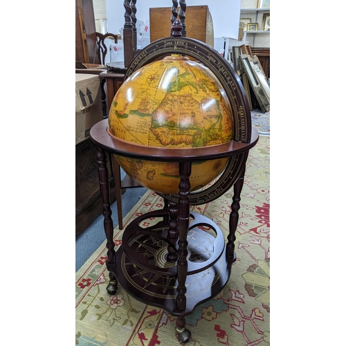 80 - A vintage globe drinks cabinet, having a hinged top opening to reveal a fitted interior, 96cm h x 51... 