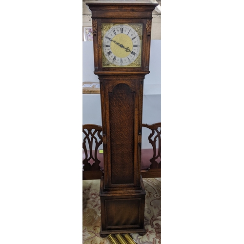 81 - An early 20th century oak long case clock, striking on eight rods and having a gilt dial with pierce... 