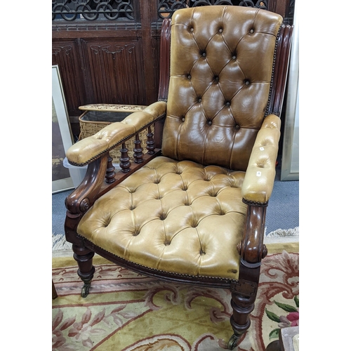 83 - A late Victorian mahogany salon armchair having green leather button back upholstery and turned supp... 