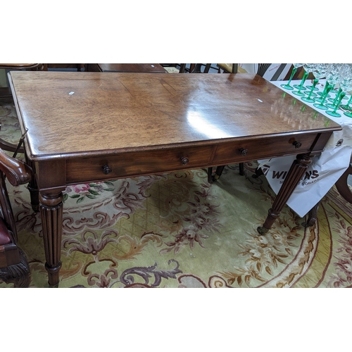 86 - A late Victorian Warring & Gillows style side table having two short drawers and reeded tapering leg... 