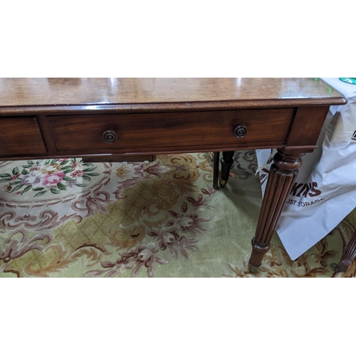 86 - A late Victorian Warring & Gillows style side table having two short drawers and reeded tapering leg... 