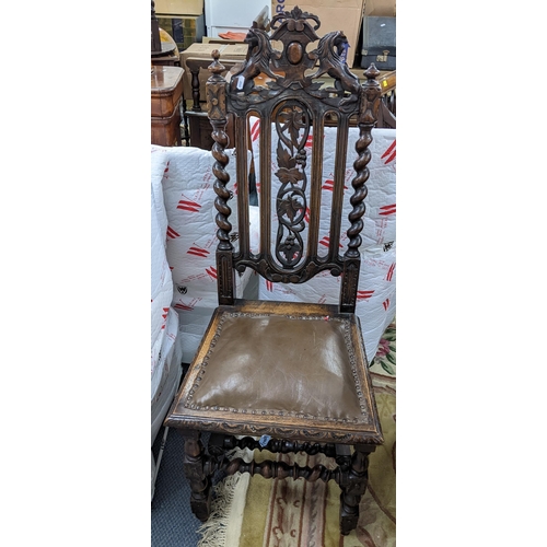 88 - A late Victorian oak carved hall chair, the top surmounted by lions and having barley twist supports... 