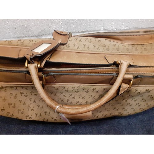 22 - Gucci-A 1960's brown canvas and leather tennis bag A/F in a rare Gucci logo having a luggage label, ... 