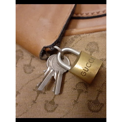 22 - Gucci-A 1960's brown canvas and leather tennis bag A/F in a rare Gucci logo having a luggage label, ... 