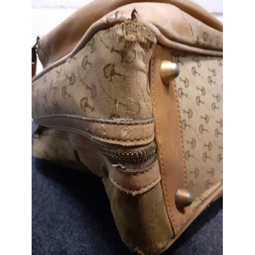 22 - Gucci-A 1960's brown canvas and leather tennis bag A/F in a rare Gucci logo having a luggage label, ... 