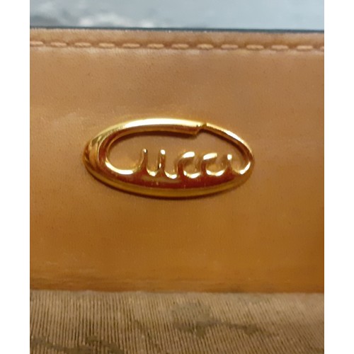 22 - Gucci-A 1960's brown canvas and leather tennis bag A/F in a rare Gucci logo having a luggage label, ... 