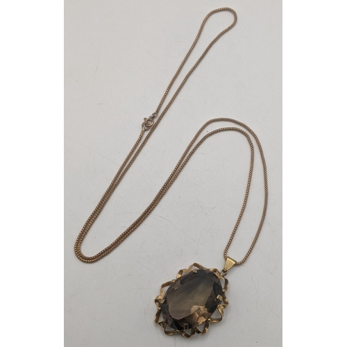 3 - A gold and smokie quartz pendant tested as 9ct gold on a 9ct gold necklace 26.3g
Location:CAB4