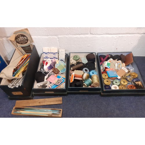 44 - Four 1920's green canvas covered wooden haberdashery boxes containing vintage knitting needles, silk... 