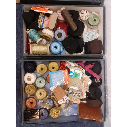 44 - Four 1920's green canvas covered wooden haberdashery boxes containing vintage knitting needles, silk... 