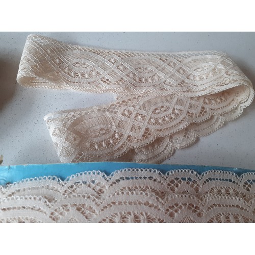 51 - A large quantity of early to mid 20th Century cream machine made lace trim, approx 2x 16m lengths an... 