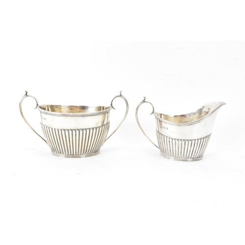 1 - A Victorian silver matched three piece tea set, comprising a teapot hallmarked London 1897, a Mappin... 