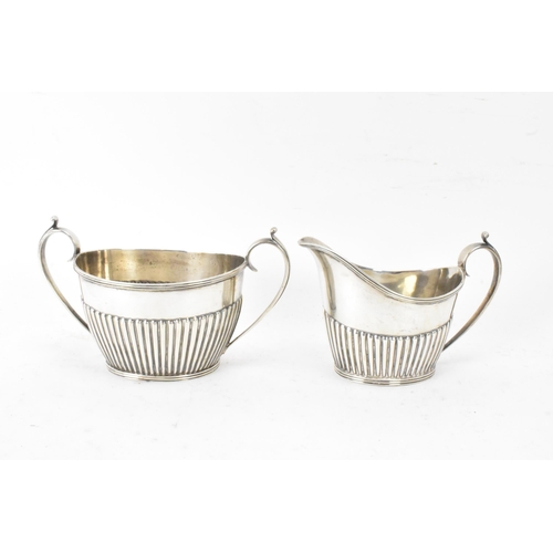 1 - A Victorian silver matched three piece tea set, comprising a teapot hallmarked London 1897, a Mappin... 