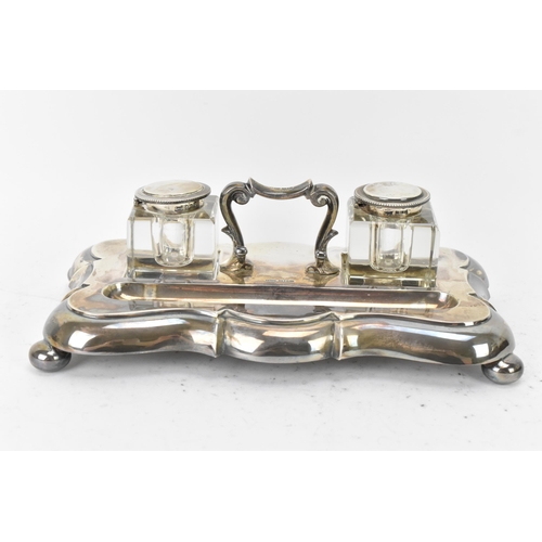 101 - A George V silver double inkstand by James Dixon & Sons, hallmarked Sheffield 1925, having a scrolle... 