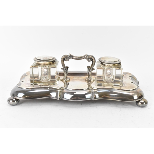 101 - A George V silver double inkstand by James Dixon & Sons, hallmarked Sheffield 1925, having a scrolle... 