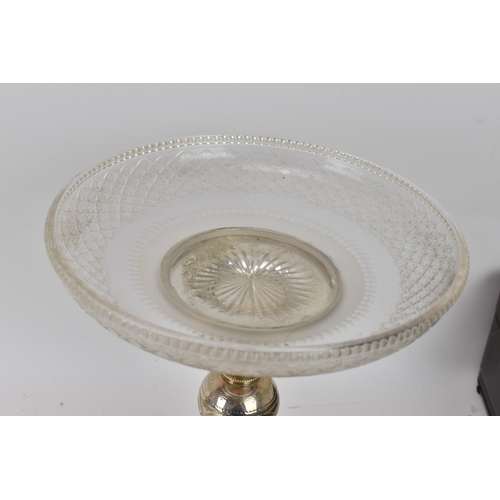 103 - A pair of late Victorian silver plated pedestal dishes, each having cut glass dishes raised by a kno... 