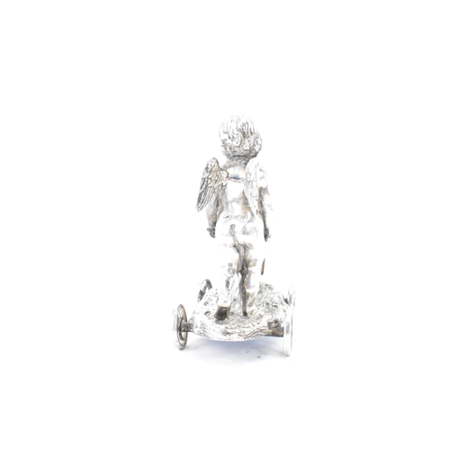 106 - A late Victorian silver plated novelty ornament, by Elkington & Co, fashioned as a cherub pushing a ... 