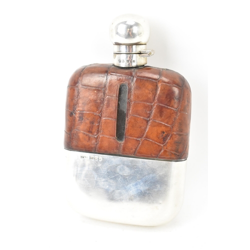 107 - A George V silver hip flask by Ollivant & Botsford, hallmarked London 1927, having a crocodile leath... 