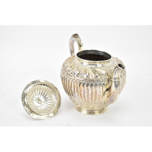 118 - A 19th century white metal small teapot, having a turned final, scroll handle with beading, embossed... 