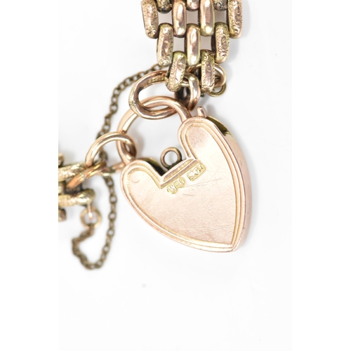 125 - A 9ct gold gate link bracelet, having a heart shaped locket with engraved detail and a safety chain,... 