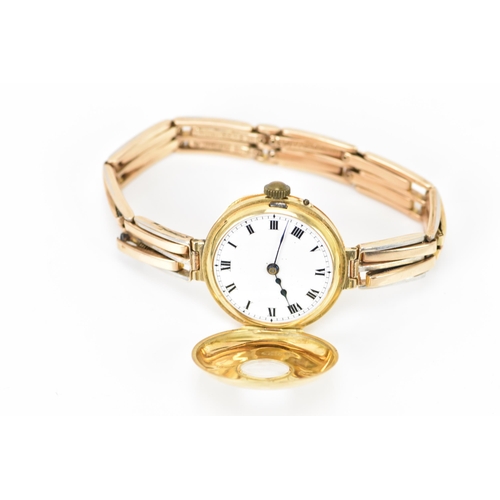 129 - An early 20th century 9ct yellow gold ladies watch, on a 9ct bi-coloured gold expanding bracelet, wh... 