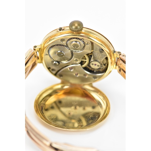 129 - An early 20th century 9ct yellow gold ladies watch, on a 9ct bi-coloured gold expanding bracelet, wh... 