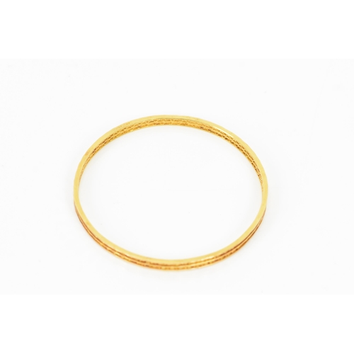 134 - An 18ct yellow gold bangle, having a pierced woven design and stamped N G F 18ct to the border, 7cm ... 