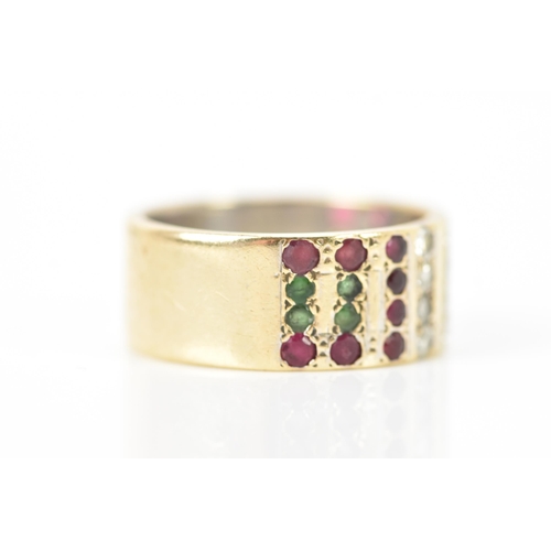 138 - A 9ct yellow and white gold ring, inset with rows of eight emeralds, sixteen rubies and twelve diamo... 