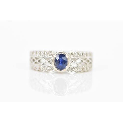 140 - A 14ct white gold sapphire and diamond dress ring, the faceted cut sapphire measuring 4.6mm x 3.5mm,... 