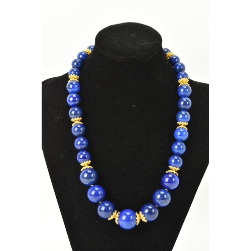 141 - A 14ct yellow gold and lapis lazuli beaded necklace, the rounded beads graduating in size, smallest ... 