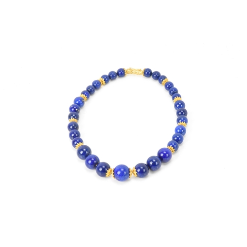 141 - A 14ct yellow gold and lapis lazuli beaded necklace, the rounded beads graduating in size, smallest ... 