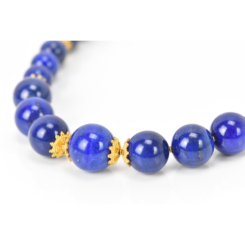 141 - A 14ct yellow gold and lapis lazuli beaded necklace, the rounded beads graduating in size, smallest ... 