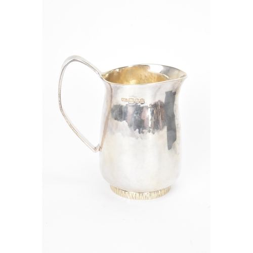 16 - An Elizabeth II silver cream jug, by Anthony Hawksley, hallmarked London 1991, the base having a bar... 