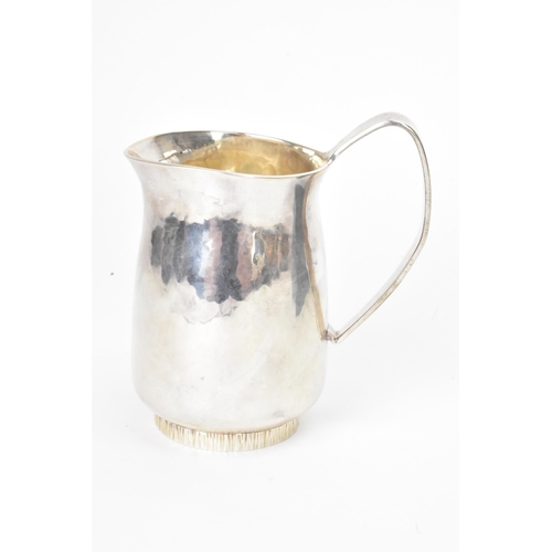 16 - An Elizabeth II silver cream jug, by Anthony Hawksley, hallmarked London 1991, the base having a bar... 