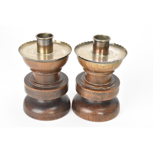 17 - A pair of George V oak and silver topped candlesticks, by F J Ross & Sons (Frederick James Ross), ha... 