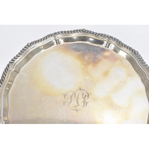 21 - An Edwardian silver salver, by Mappin & Webb, hallmarked Sheffield 1906, having a gadrooned rim, eng... 