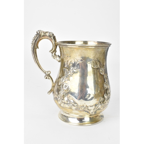 22 - A Victorian silver mug, by Robert Harper, hallmarked London 1857, the embossed baluster formed body ... 